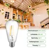 A vintage-style LED light bulb is shown in the foreground, with a cafe-like interior setting in the background. Produktbild-Vorschau