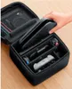 A hand is placing a Nintendo Switch console into a black carrying case that is organized with compartments for accessories. Náhled obrázku produktu
