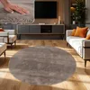 A living room scene featuring a round rug, sofa, and entertainment center. Produktbild-Vorschau