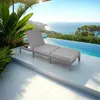 A chaise lounge with an ottoman sits on a tiled patio next to an infinity pool overlooking the ocean. Voir les images du produit