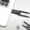 A close-up shot of a laptop keyboard and a wireless USB adapter. Produktbild-Vorschau