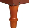 A close-up view of a brown leather armchair leg. Produktbild-Vorschau