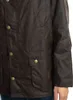 Close-up of a brown waxed jacket with brass buttons and pockets. Produktbild-Vorschau