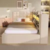 A bedroom scene featuring a bed with a headboard and integrated shelving unit. Produktbild-Vorschau