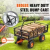 A heavy-duty steel dump cart filled with firewood, shown outdoors on a grassy lawn. Voir les images du produit