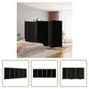 A bedroom scene with a bed and a black room divider. Produktbild-Vorschau