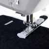 A close-up of a sewing machine needle and presser foot working on dark fabric. Produktbild-Vorschau