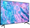 A side view of a modern flat-screen television with a colorful abstract image displayed on its screen, resting on its black stand. Produktbild-Vorschau
