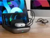 A charging station for multiple devices on a wooden desk. Anteprima dell’immagine prodotto