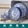 A set of blue and white patterned plates and bowls are neatly arranged in a dishwasher rack. Produktbild-Vorschau