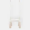 A white indoor swing with beige tassels hanging from the bottom, set against a plain white background. Náhľad obrázku produktu