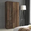 A wooden cabinet is shown in a room with a concrete wall and a floor lamp. Voir les images du produit