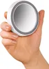 A hand holding a compact mirror. Anteprima dell’immagine prodotto