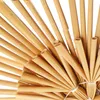 A close-up view of a star-shaped Christmas tree topper made of straw. Produktbild-Vorschau