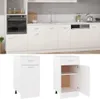 A white kitchen cabinet with drawers and a door, shown both closed and open, with a larger kitchen scene in the background. Náhľad obrázku produktu