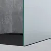 A close-up view of a modern shower enclosure with a concrete wall and a frosted glass panel. Produktbild-Vorschau