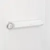 A white retractable clothesline mounted on a white wooden wall. Náhled obrázku produktu