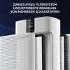 Close-up view of a white air purifier with its filters exposed, set against a dark blue background with text overlay. Produktbild-Vorschau