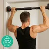A man is doing pull-ups on a doorway pull-up bar. Náhled obrázku produktu