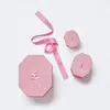 Pink Swarovski boxes and ribbon on a white background. Produktbild-Vorschau
