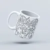 A white mug with a black outline pattern of race tracks, set against a light gray background. Náhled obrázku produktu