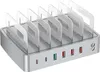 A silver multi-device charging station with clear dividers, shown from a front-side angle on a white background. Náhled obrázku produktu