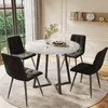 A dining set with a round marble-top table and four black upholstered chairs, placed on a rug in a well-lit room with a window. Anteprima dell’immagine prodotto