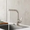 A modern kitchen faucet with water running into a sink. Anteprima dell’immagine prodotto