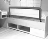 A black and white image of a bed with a bed rail and a bedside table. Produktbild-Vorschau