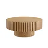A round coffee table with a fluted wooden base and top, presented against a white background. Produktbild-Vorschau