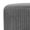 A close-up view of the side of a gray, pleated velvet ottoman. Podgląd zdjęcia produktu