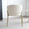 The back view of a cream-colored boucle accent chair with gold metal legs. Náhled obrázku produktu