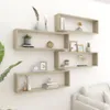 A set of four wooden cube shelves mounted on a white wall, decorated with various items. Náhled obrázku produktu