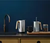 A collection of modern kitchen appliances including a kettle, French press, and coffee grinder on a countertop. Anteprima dell’immagine prodotto
