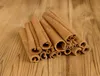 A pile of dried cinnamon sticks on a wooden surface. Produktbild-Vorschau
