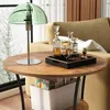 A round wooden side table with a green glass lamp and a decanter set on a tray. Náhľad obrázku produktu