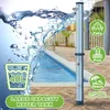 A solar garden shower is shown next to a swimming pool with water splashing around it. Náhľad obrázku produktu