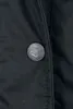 A close-up of a black button on a black garment. Produktbild-Vorschau