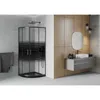 A modern bathroom with a black-framed shower cabin and a floating vanity with a sink. Podgląd zdjęcia produktu