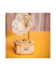 A wooden model of a gramophone is displayed on a yellow surface with a pinkish background. Podgląd zdjęcia produktu