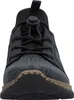 A close-up, front-facing view of a black sneaker with a patterned design. Voir les images du produit