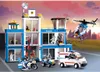 A toy police station with vehicles and figures, set against a stylized cityscape and sky. Náhľad obrázku produktu