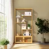 A wooden bookshelf with various items on its shelves, placed near a window with sheer curtains. A potted plant is on the right side. Produktbild-Vorschau