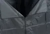 A close-up view of the zipper and fabric of a black outdoor storage cover. Produktbild-Vorschau