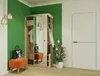 A hallway with a wardrobe, bench, and plant. Náhled obrázku produktu