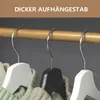 Close-up of three wooden hangers with sweaters on a wooden rod. Náhled obrázku produktu
