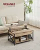 A lift-top coffee table is shown in a living room setting next to a sofa, with a laptop and a cup on its surface. Produktbild-Vorschau