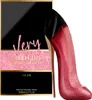 A perfume bottle shaped like a high-heeled shoe next to its packaging. Anteprima dell’immagine prodotto