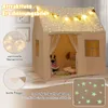 A child's play tent decorated with lights and flags, with stuffed animals inside. Podgląd zdjęcia produktu