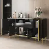 A black sideboard with gold accents and open doors, displaying decorative items and books. Produktbild-Vorschau